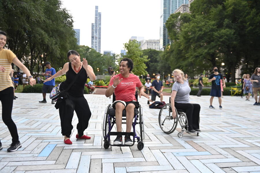 People of all abilities dancing together at Chicago SummerDance, including participants in wheelchairs, enjoying a lively outdoor event in the city.